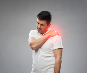 Person experiencing back pain, clutching their lower back in discomfort, seeking relief through Warragul chiropractic care for pain management and improved mobility.