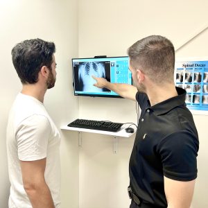 A warragul chiropractor showing the digital x-ray of his patient