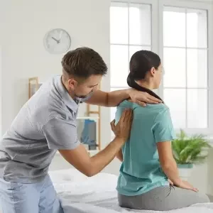 corrective chiropractor doing a back assessment